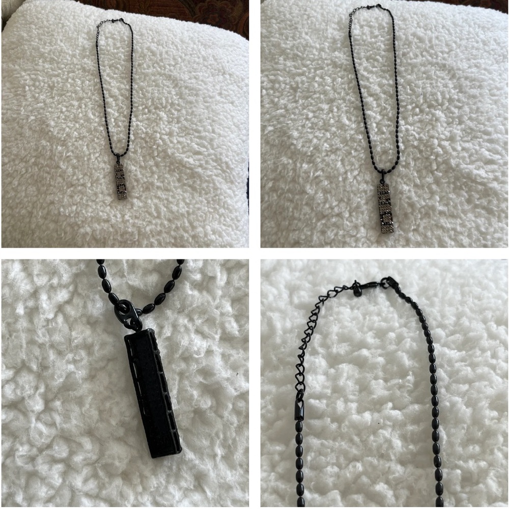 Necklace. Vertical black colored necklace and chain with faux stones.